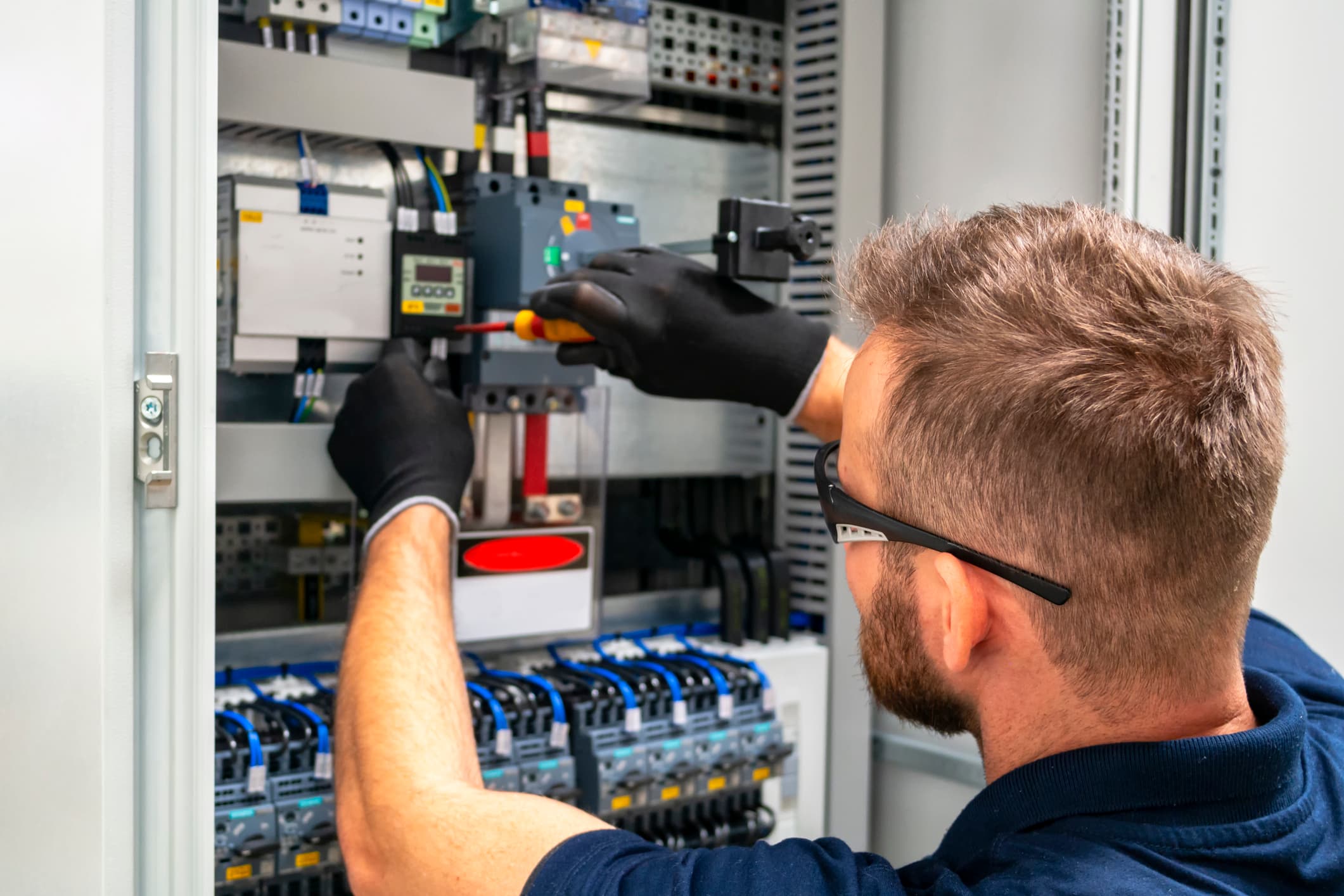 An electrician snipping wires